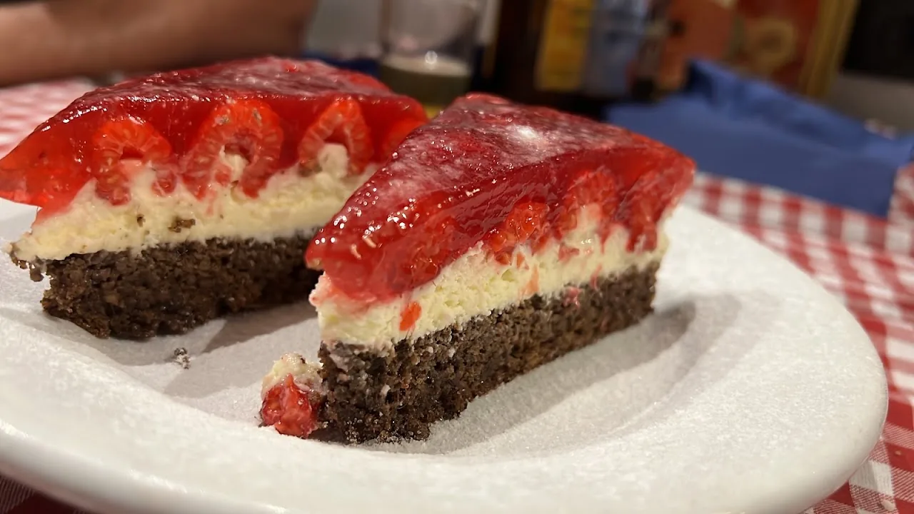 Two slices of strawberry layer cake on a plate