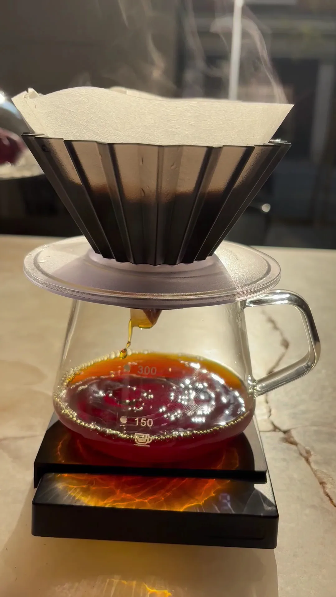 Pour-over coffee dripping through a paper filter