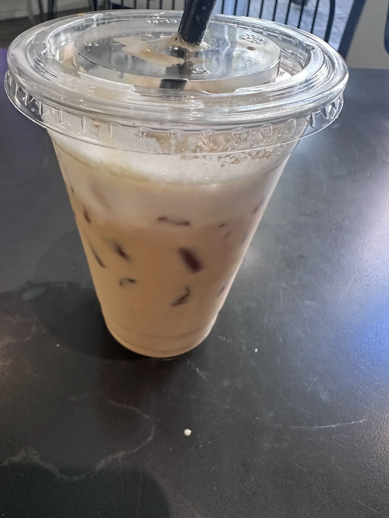 An iced coffee drink in a clear plastic cup
