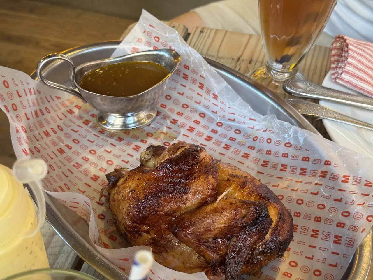 A whole roasted chicken served with a side of gravy