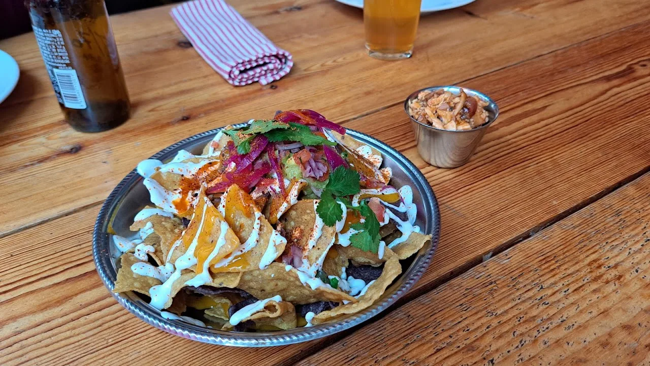 A plate of loaded nachos with toppings