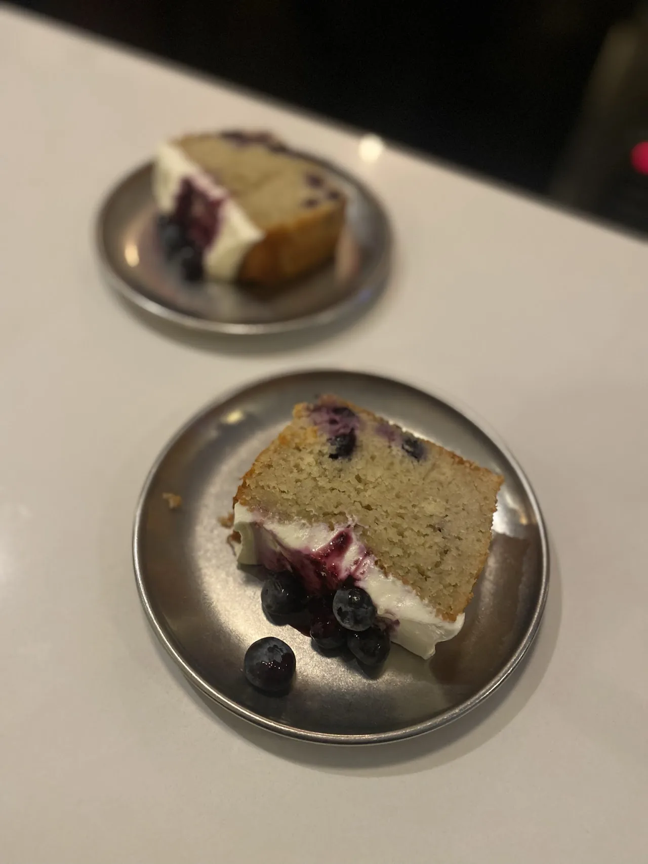 Two slices of layered cake on small plates