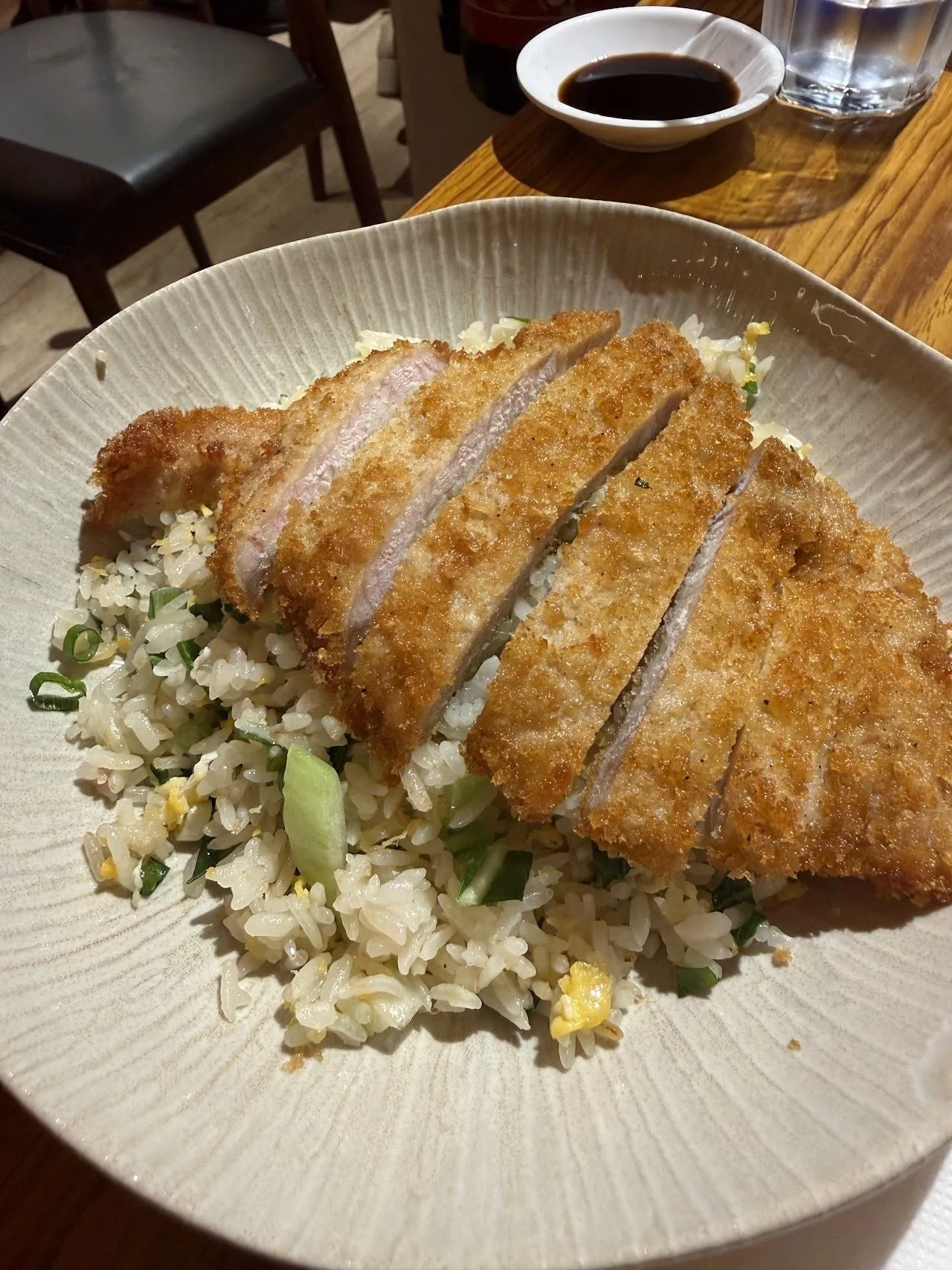 A breaded pork cutlet sliced over fried rice