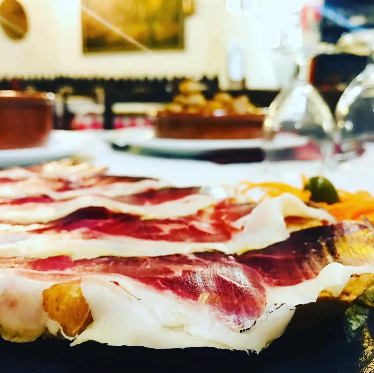 Close-up of thinly sliced cured ham on a plate at Restaurant La Llar de Foc