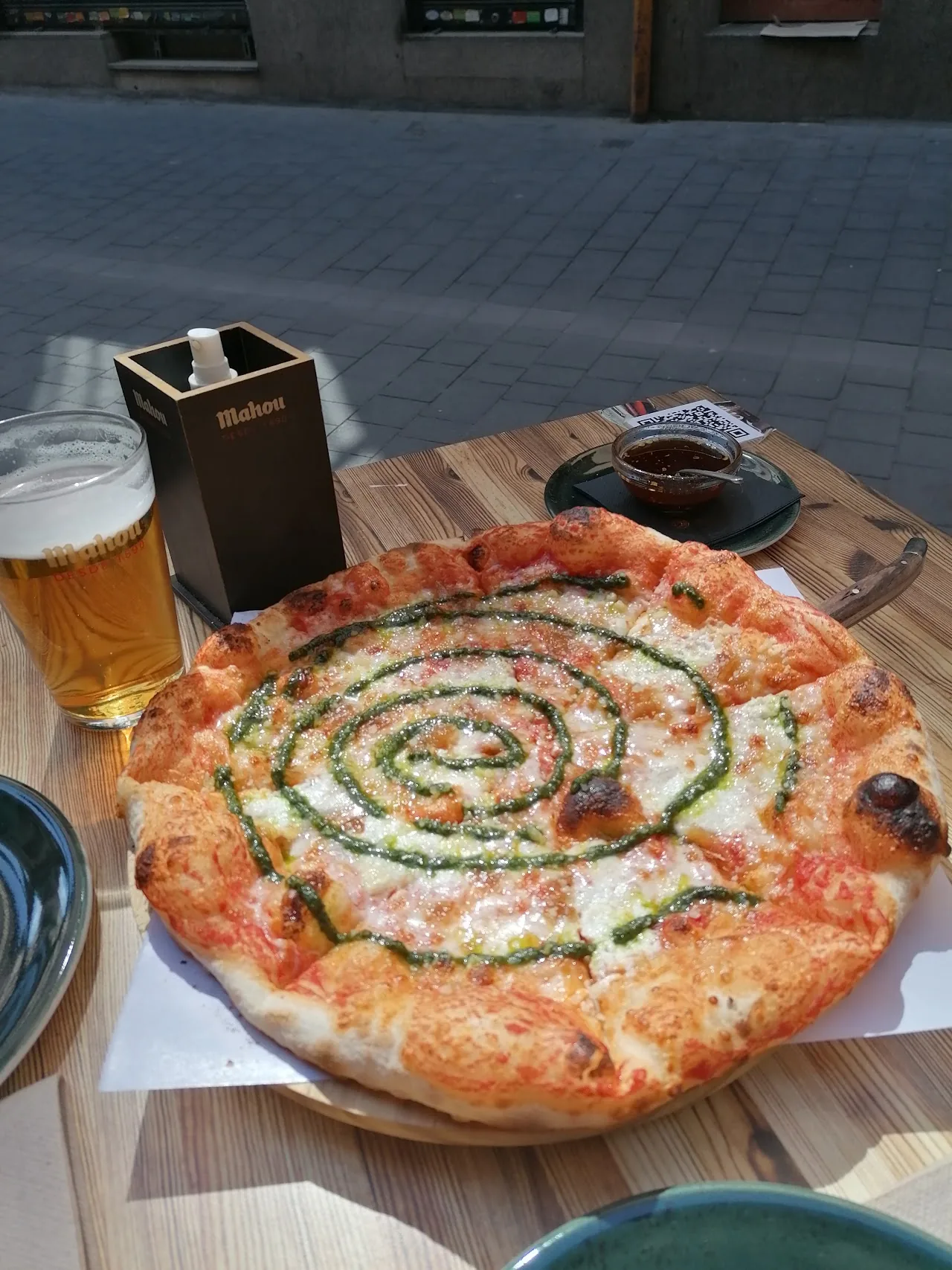 A pesto swirl pizza served with beers on the table