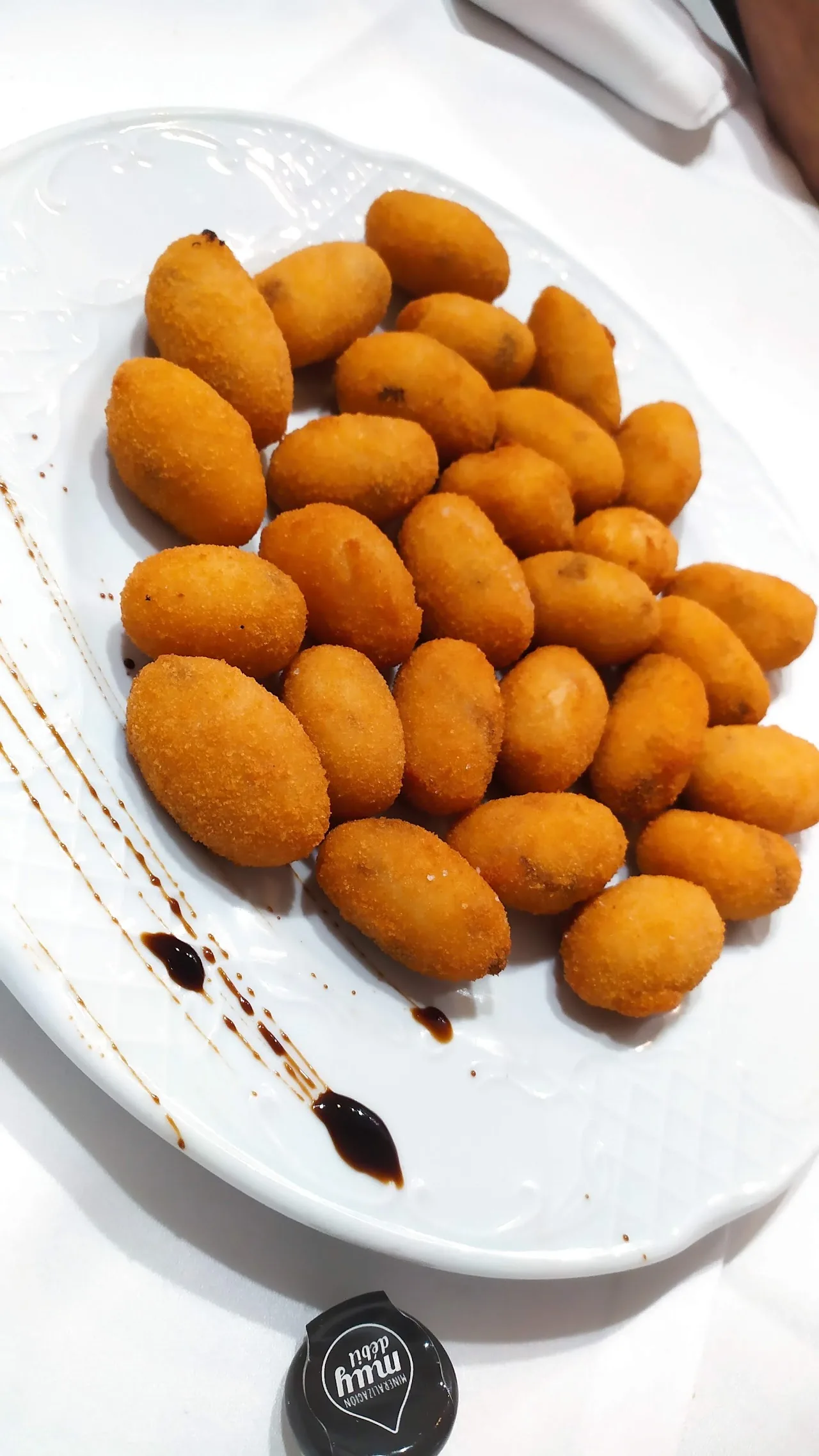 A plate of breaded croquettes