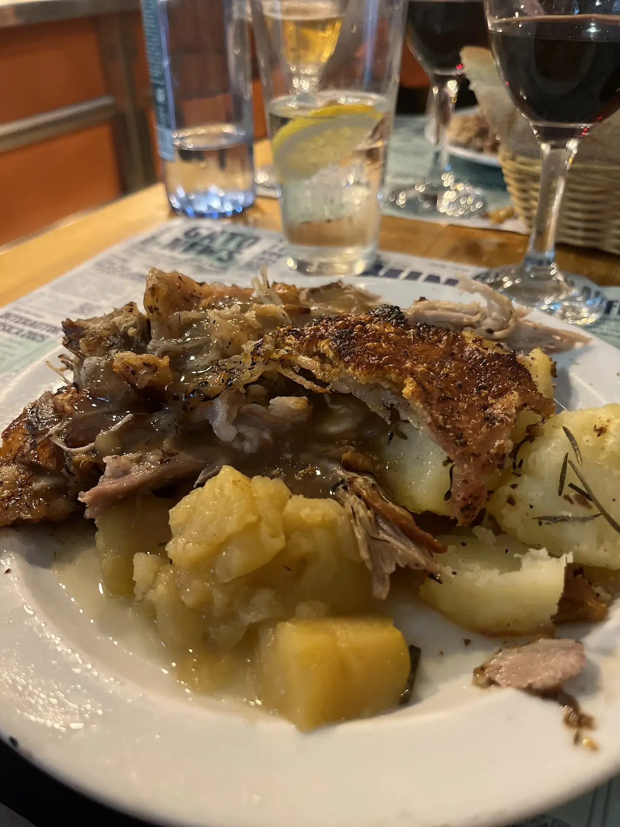 Roasted crispy-skinned meat with pan juices, apple compote and roasted potatoes