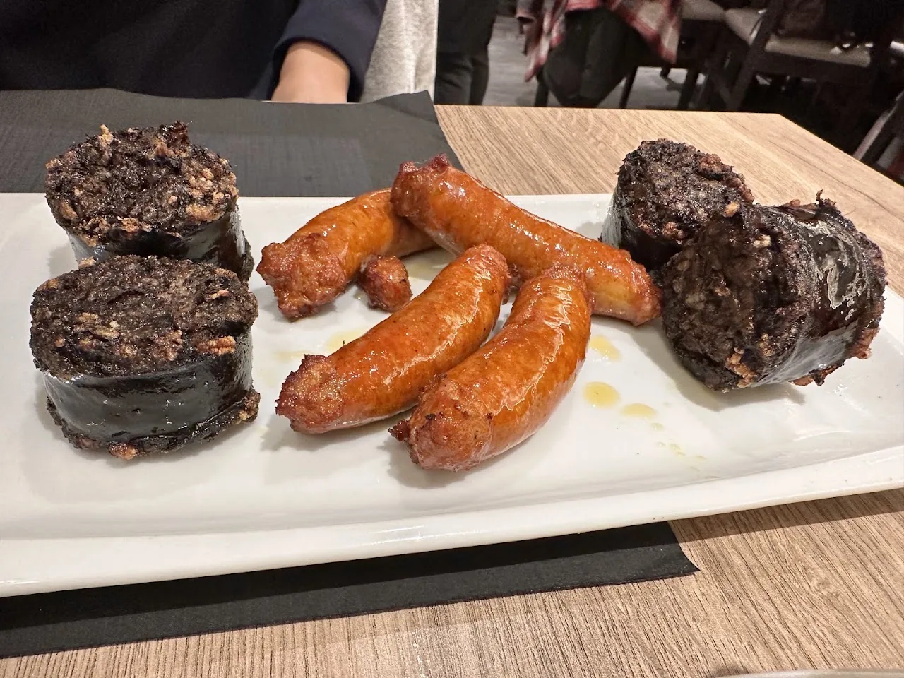A plate of grilled morcilla and chorizo sausages