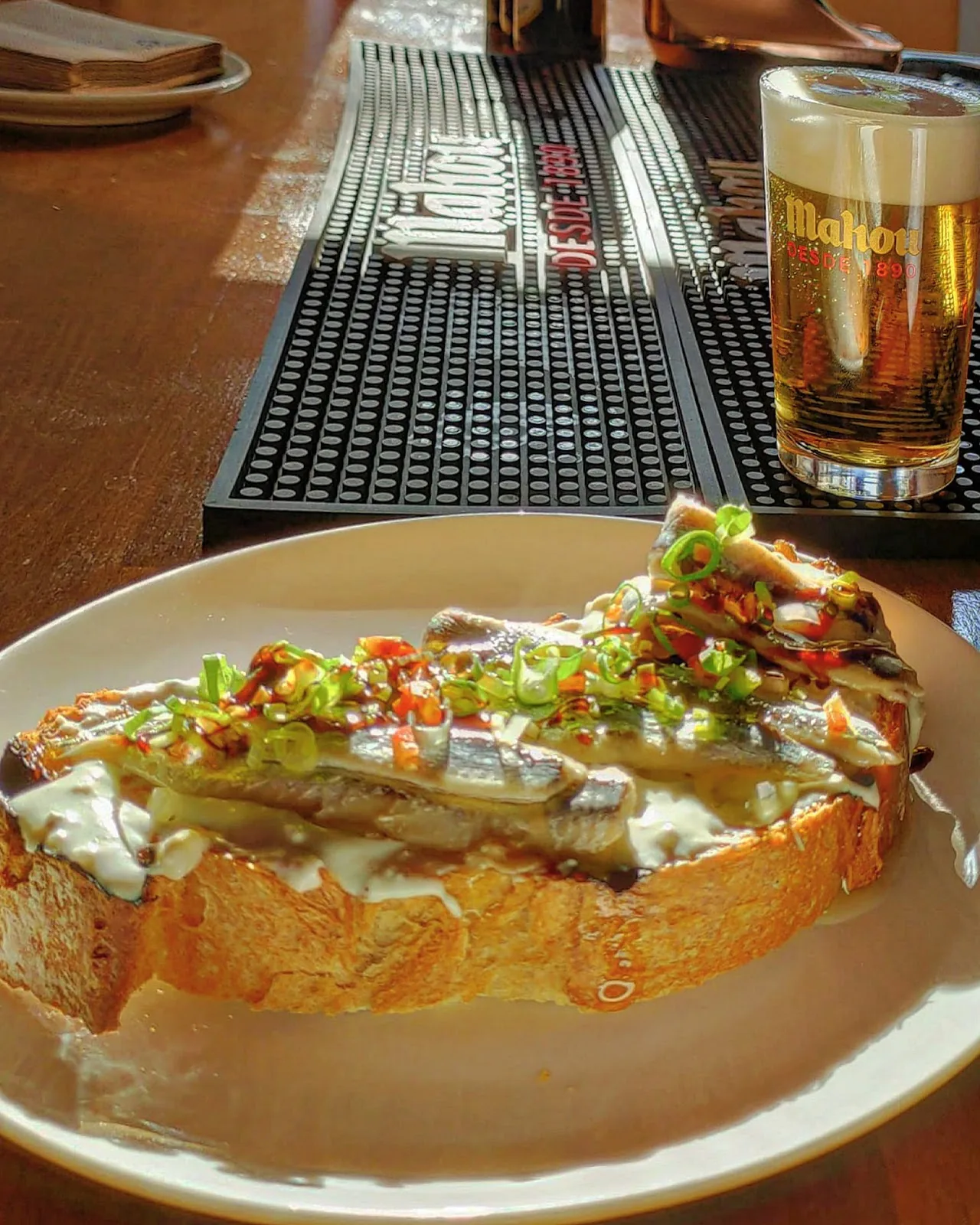 A slice of toast topped with vegetables and sauce