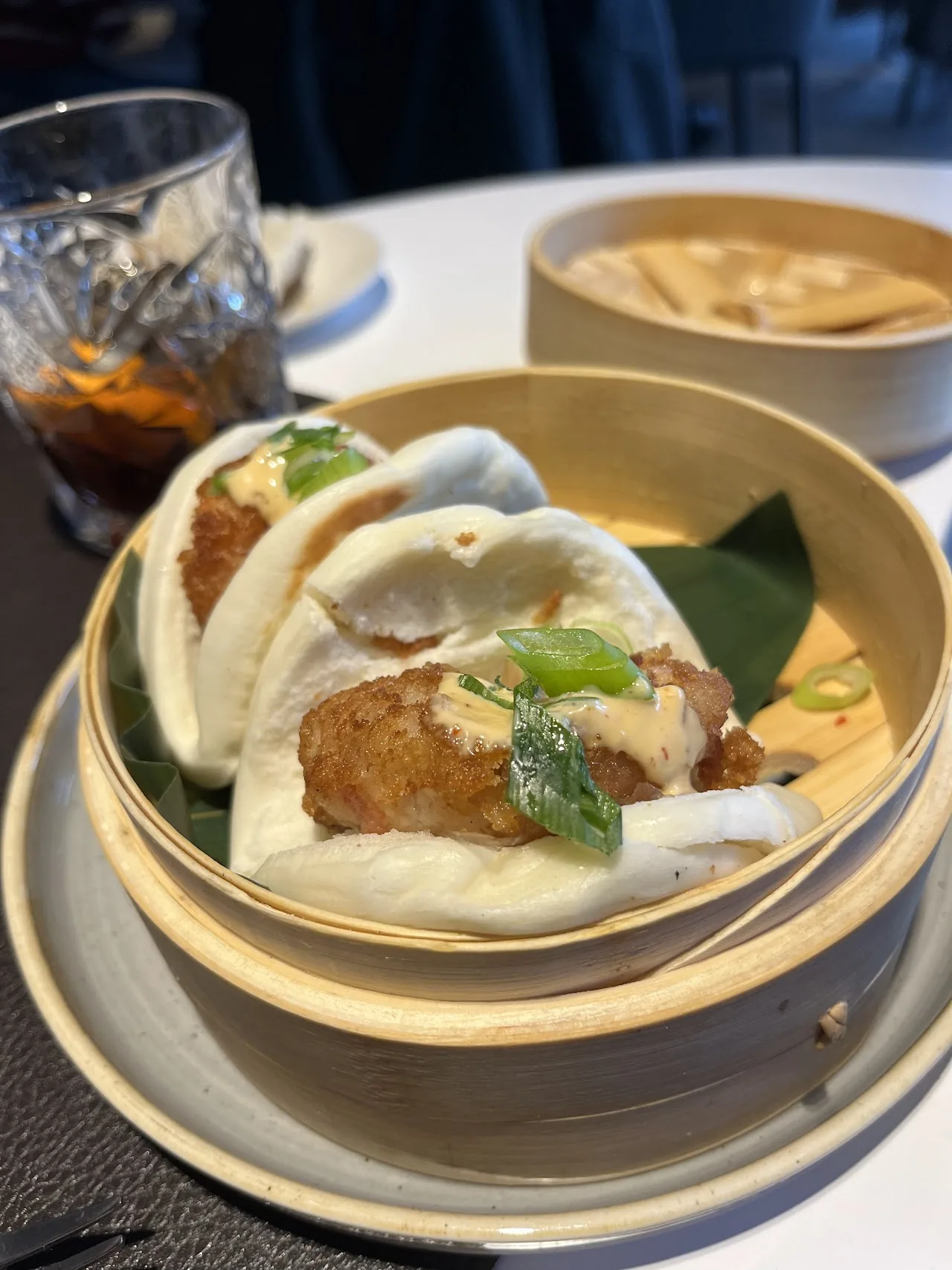 Steamed bao buns in a bamboo basket