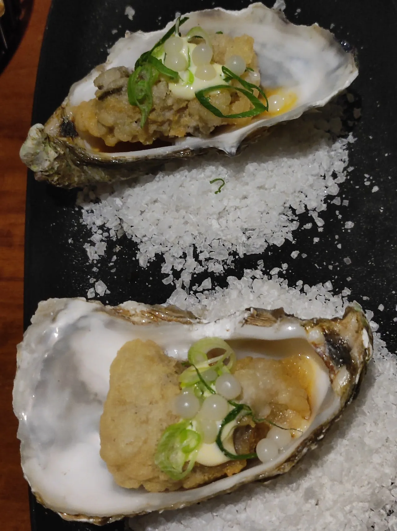 Two oysters on a bed of salt
