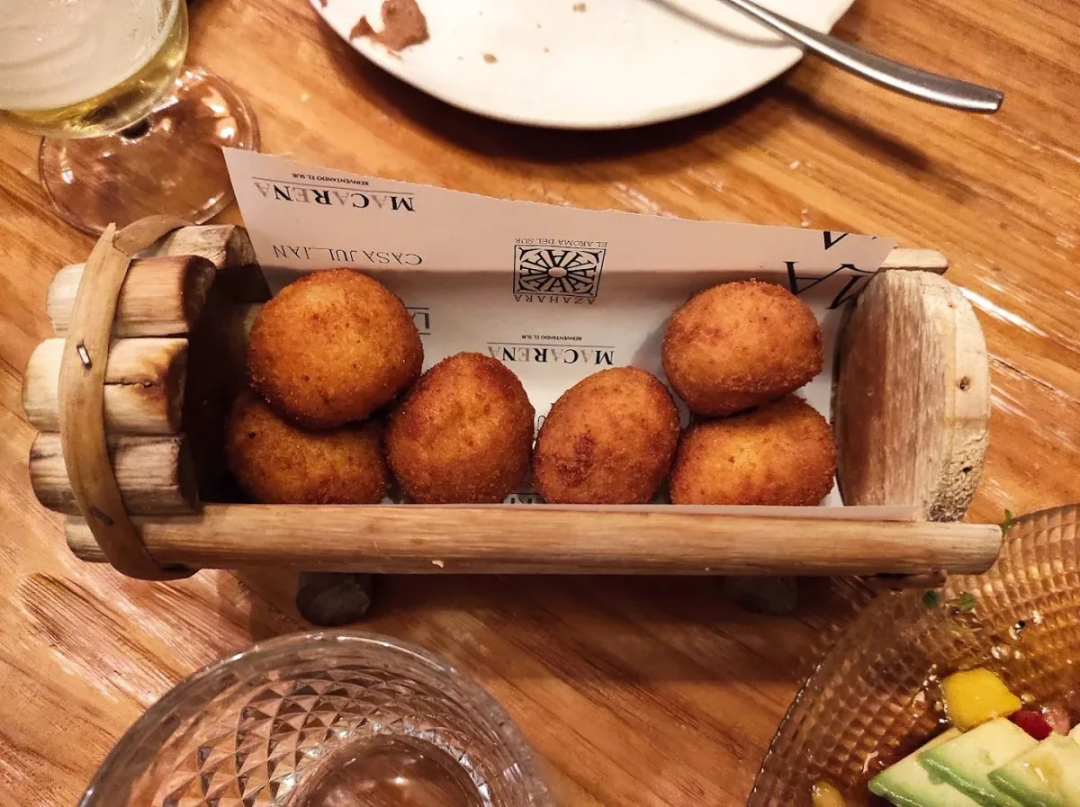 A wooden crate of fried croquettes
