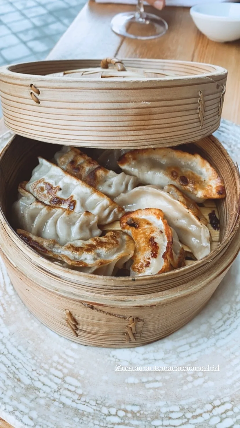 Steamed dumplings in a bamboo steamer basket