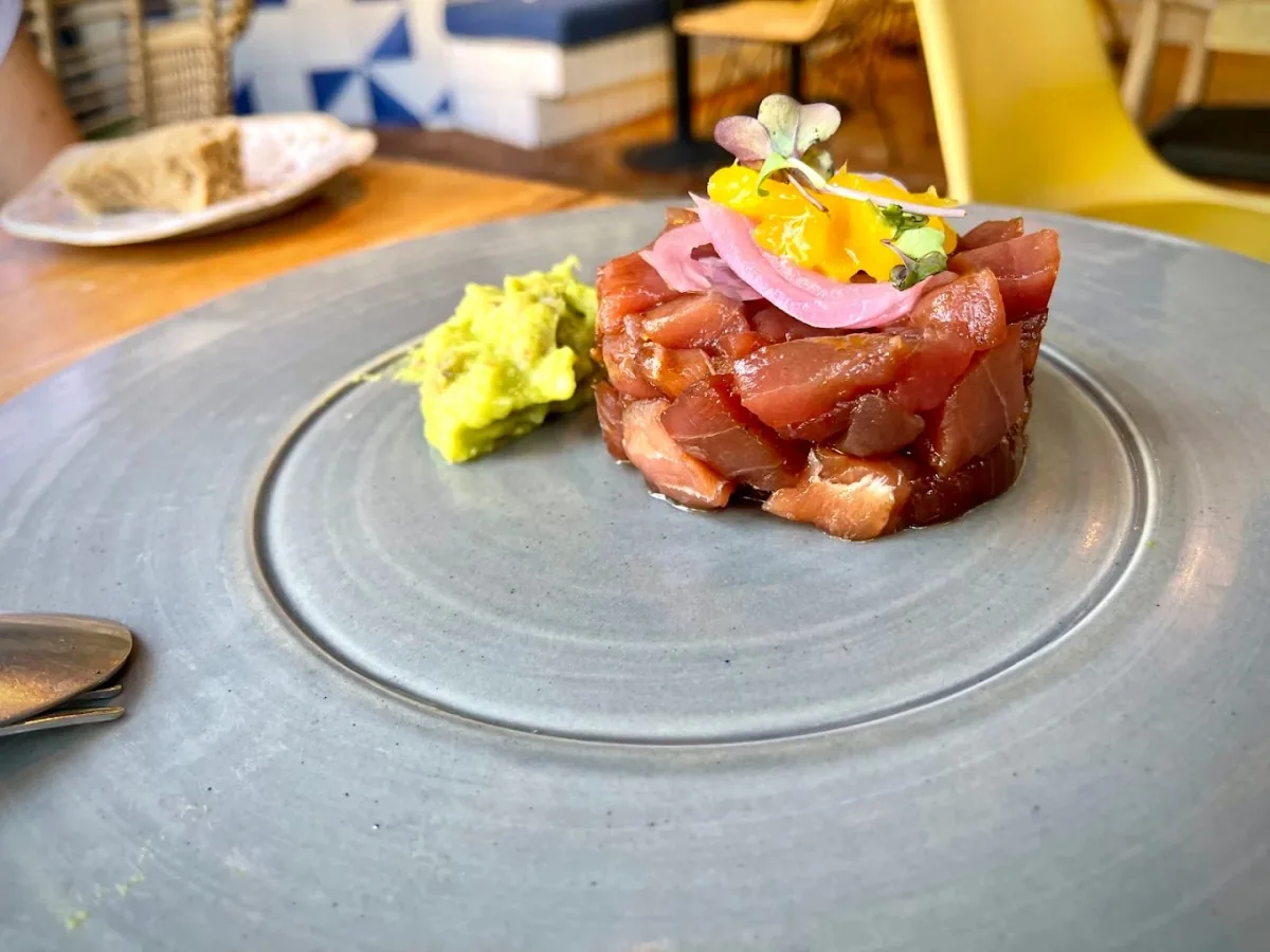 A tartare dish garnished with wasabi and pickled onion