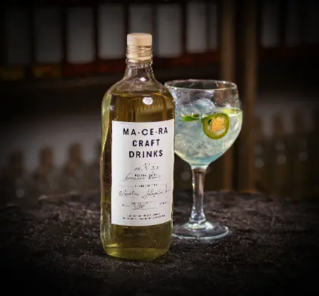 Macera Craft Drinks bottle beside a balloon glass gin and tonic garnished with jalapeno