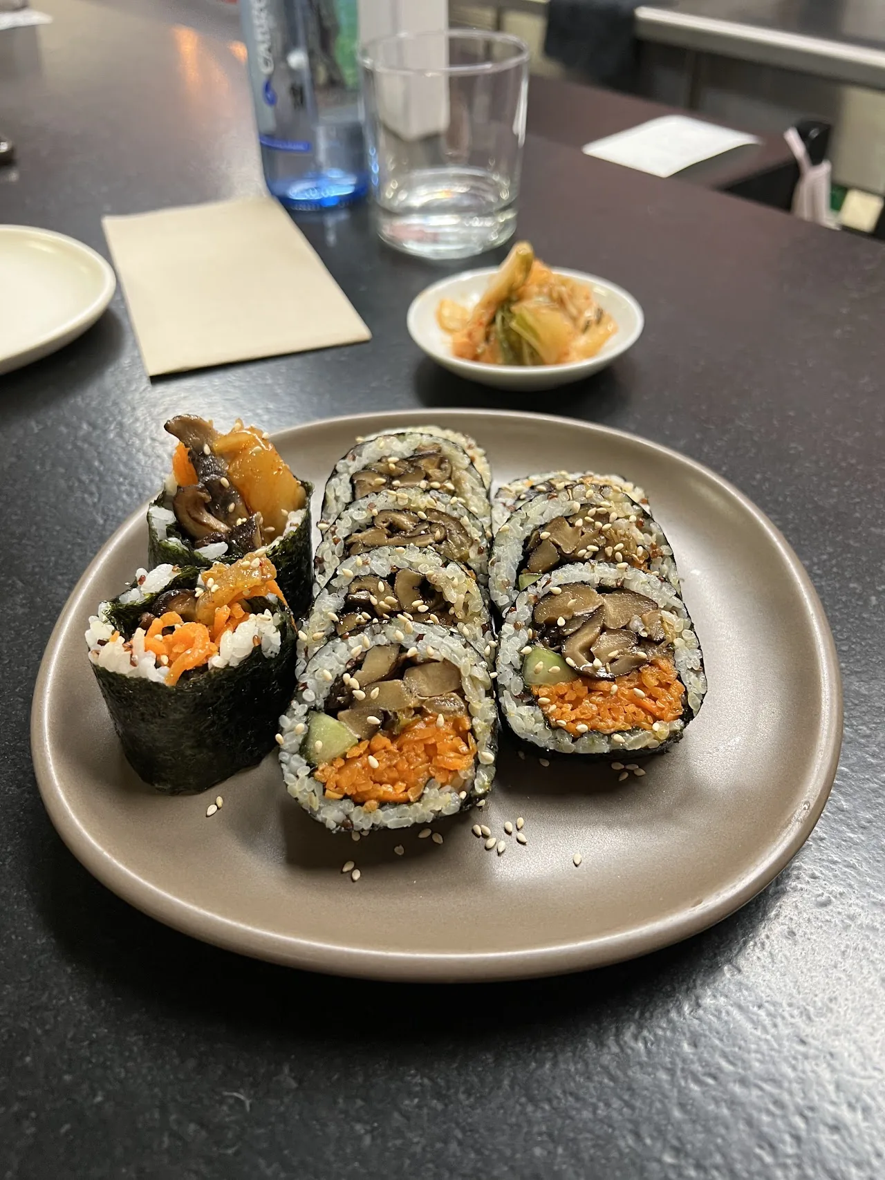 A plate of Korean-style sushi rolls with side dishes