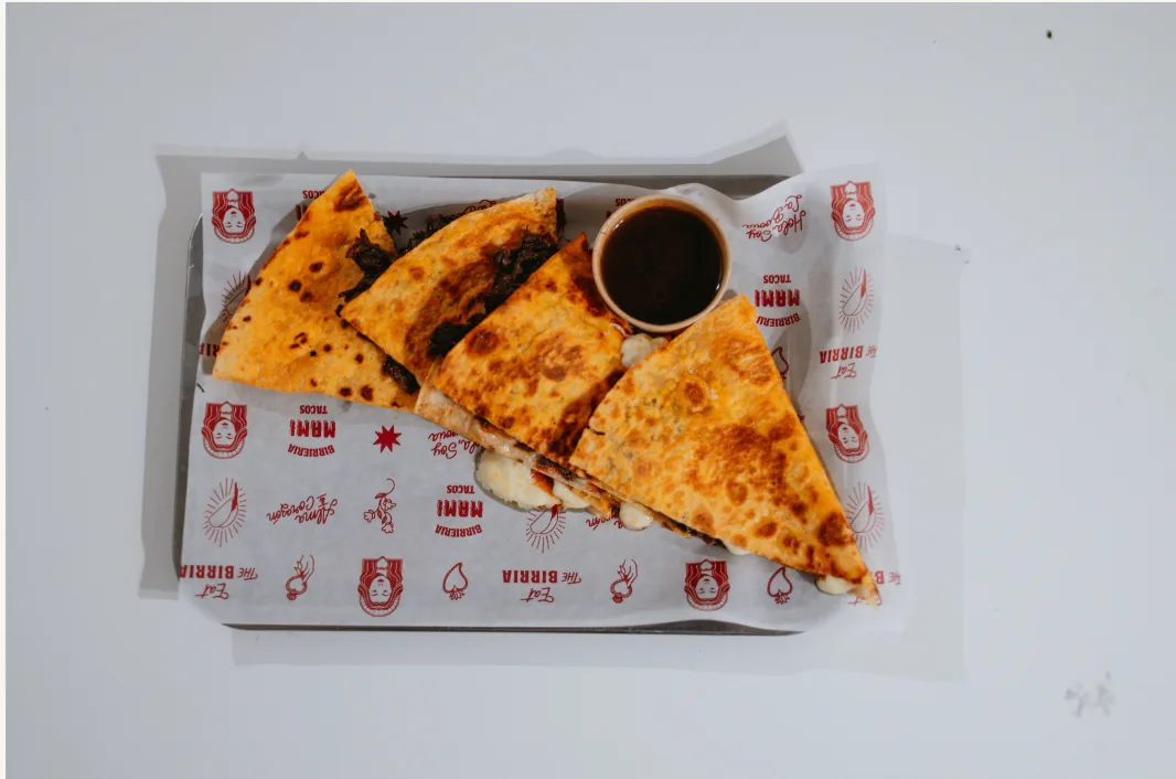 Cheese quesadillas cut into triangles with a dipping sauce