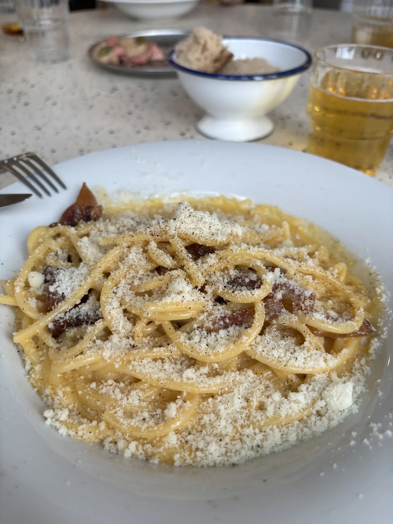 A plate of spaghetti tossed with pecorino cheese and black pepper