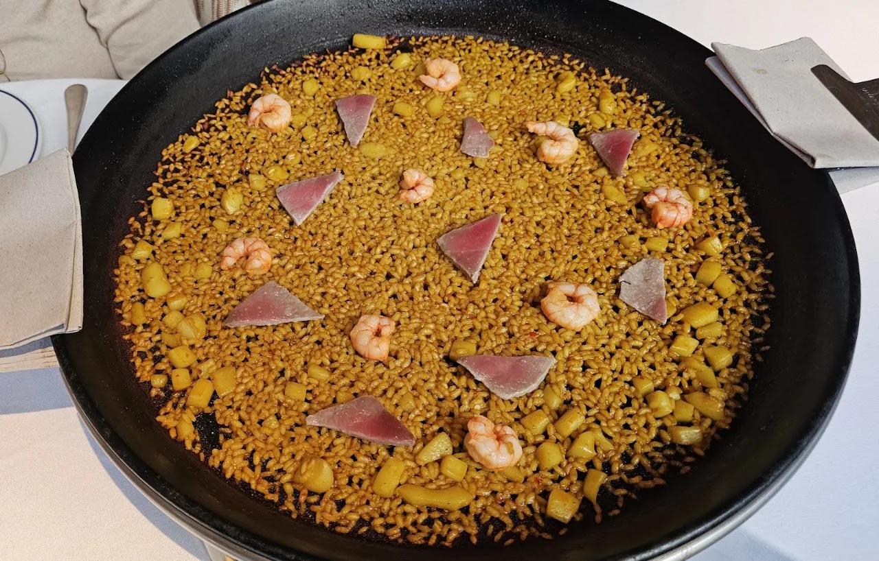 A pan of seafood paella with shrimp and scallops