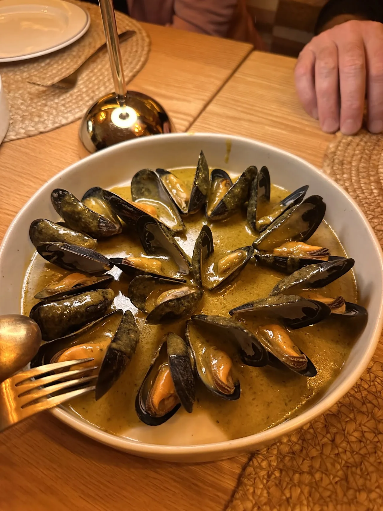 A bowl of mussels in broth