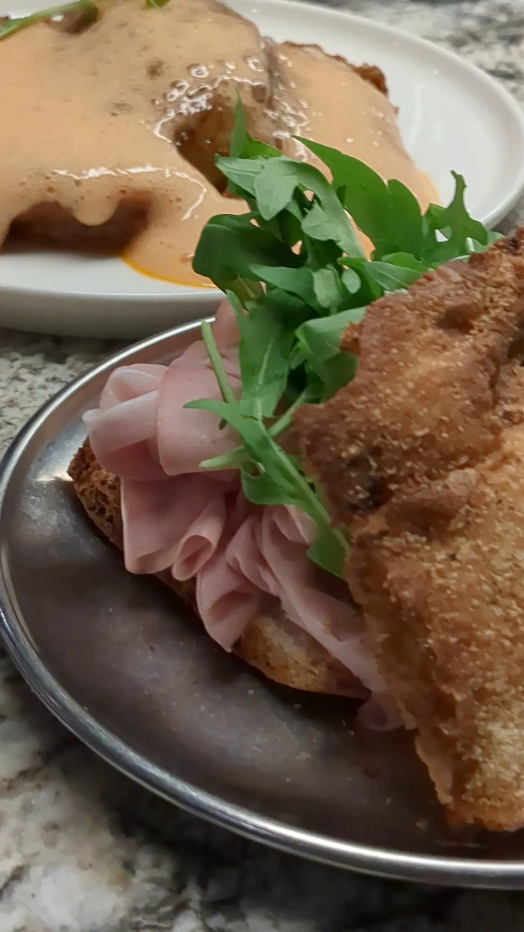 A ham and arugula sandwich on crusty bread