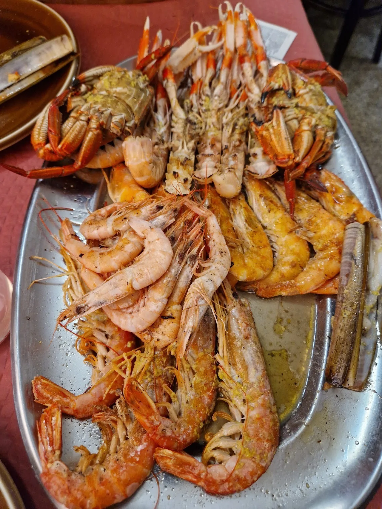 Grilled prawns and langoustines on a metal tray