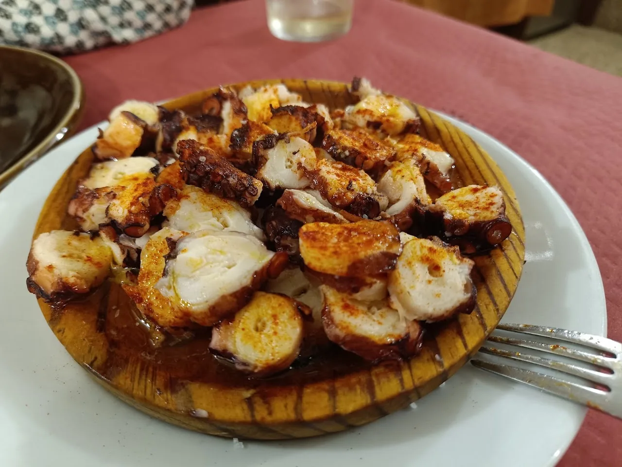Grilled octopus and scallops on a wooden board