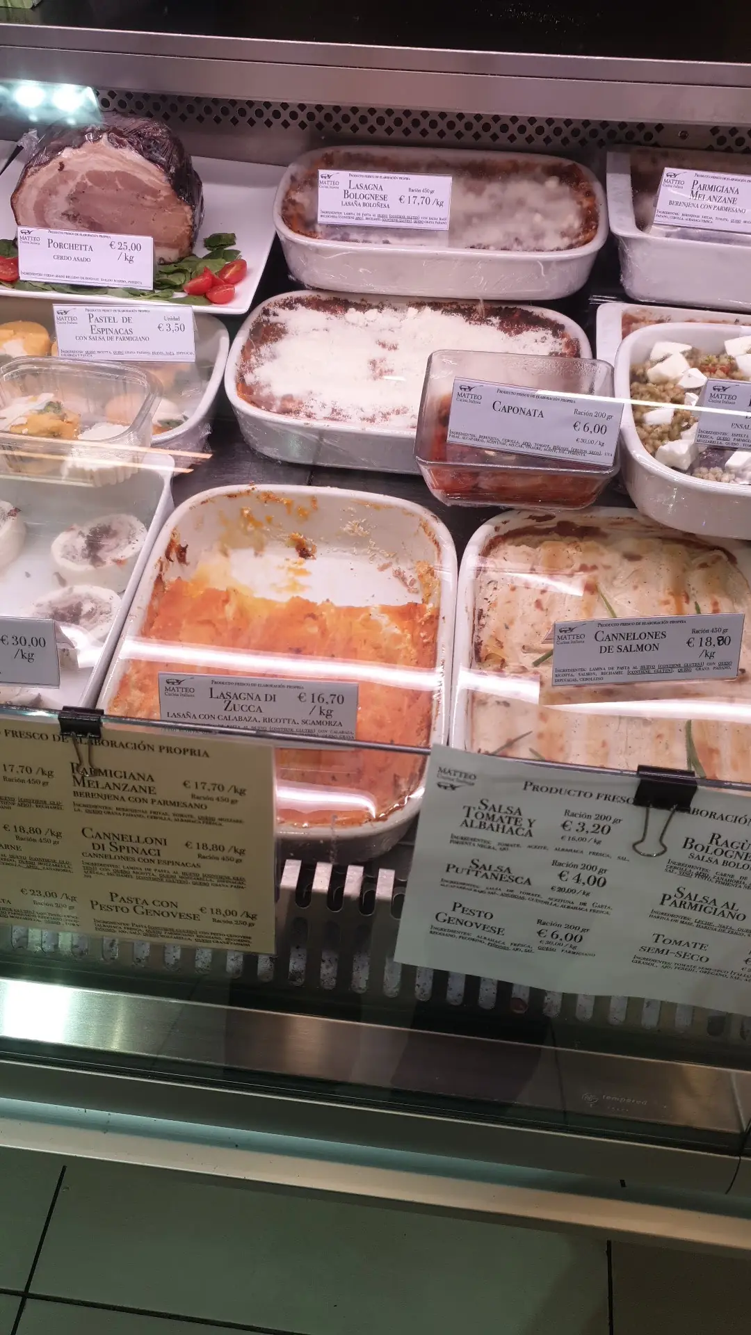 Deli case with porchetta, lasagna bolognese, lasagna di zucca and salmon cannelloni