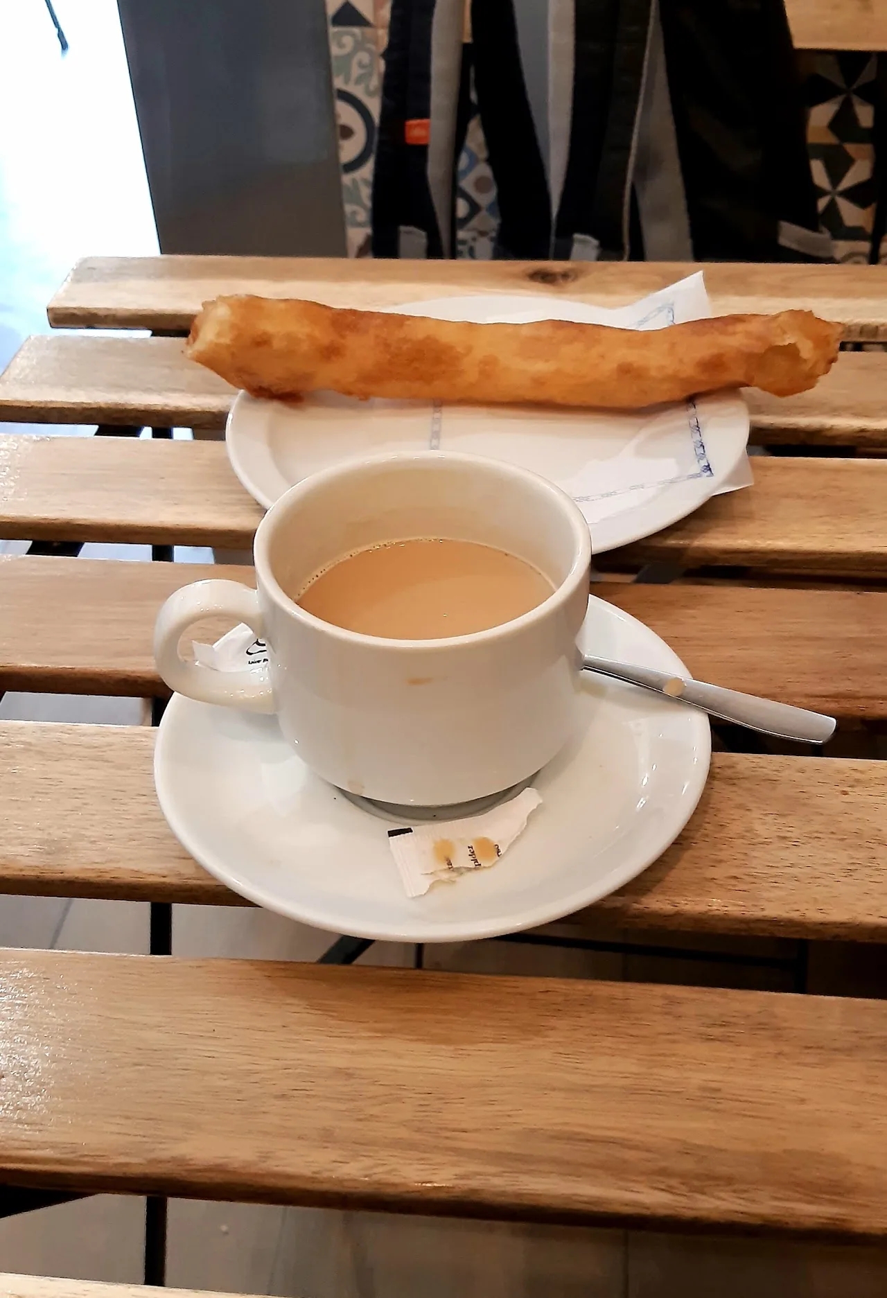 Churros served with a cup of coffee