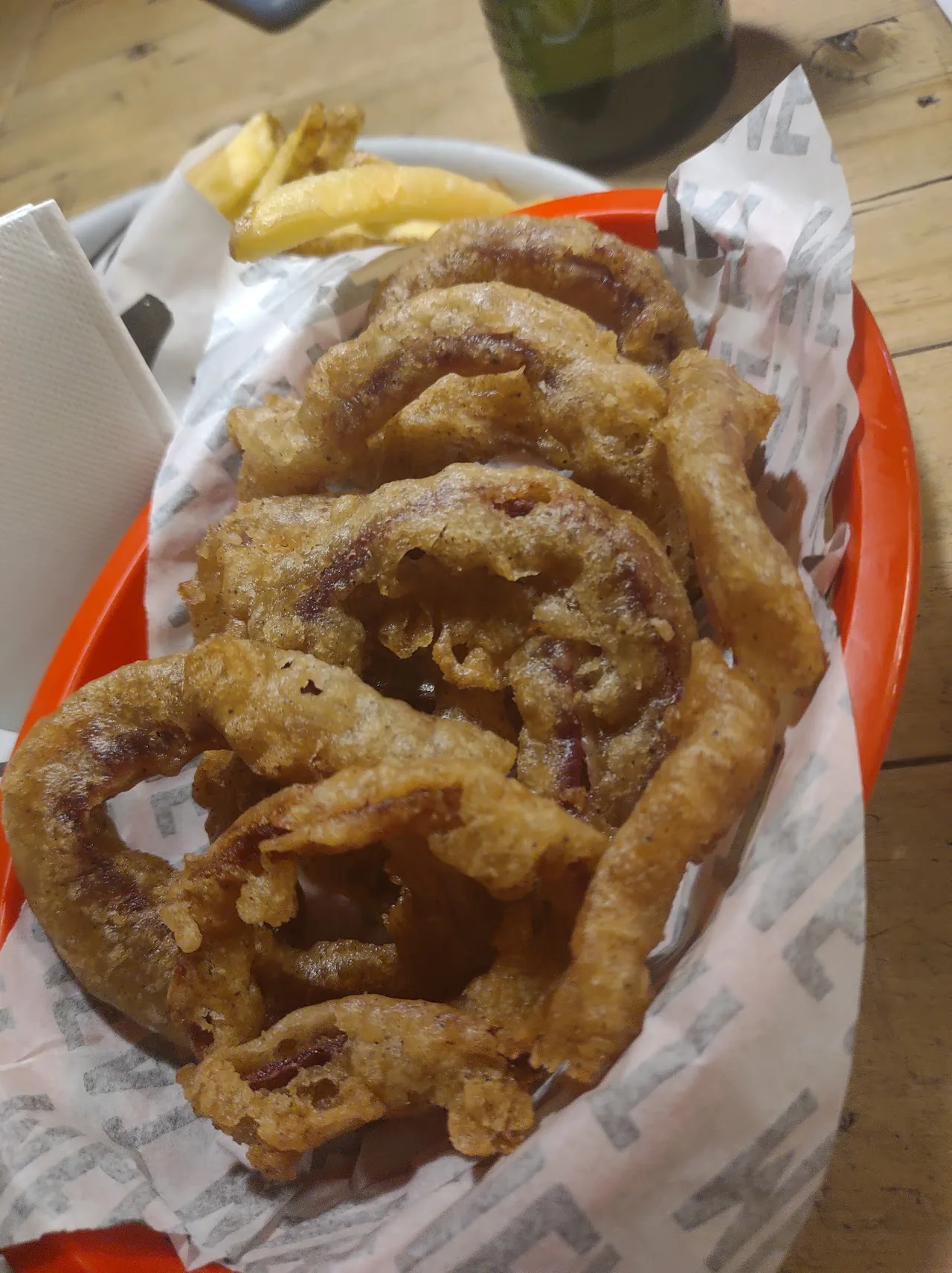 A basket of crispy fried onion rings