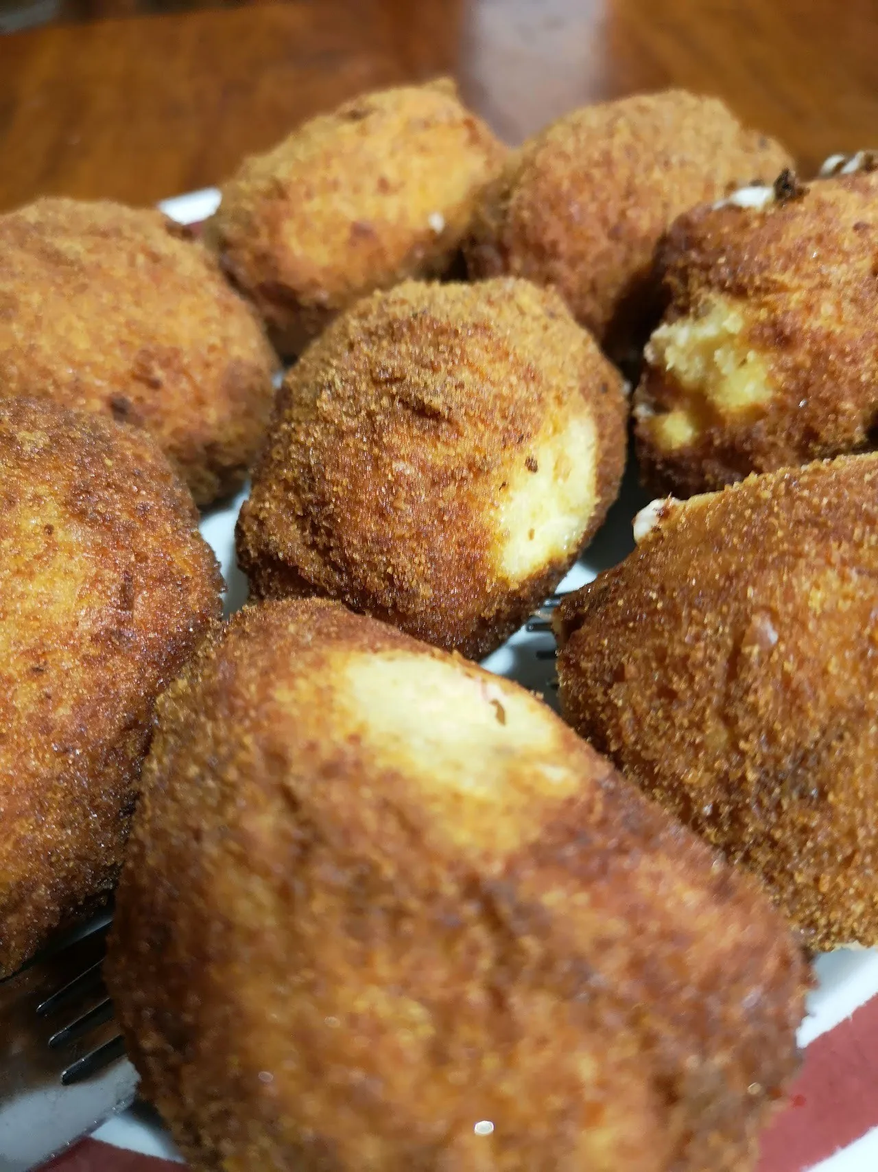 Close view of golden breaded croquettes