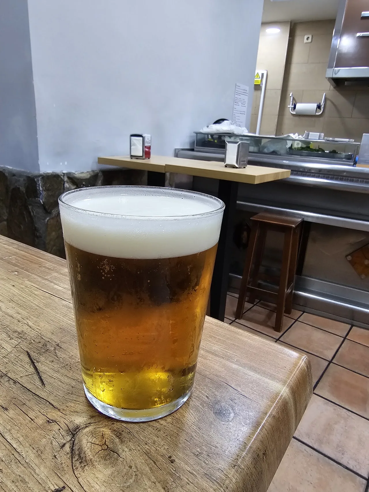 A glass of beer on a wooden table