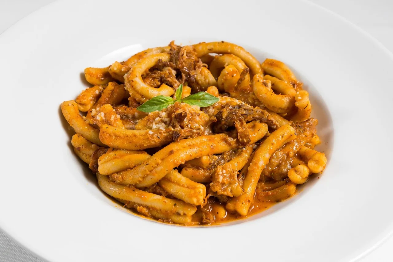 A plate of casarecce pasta in a meat ragu sauce