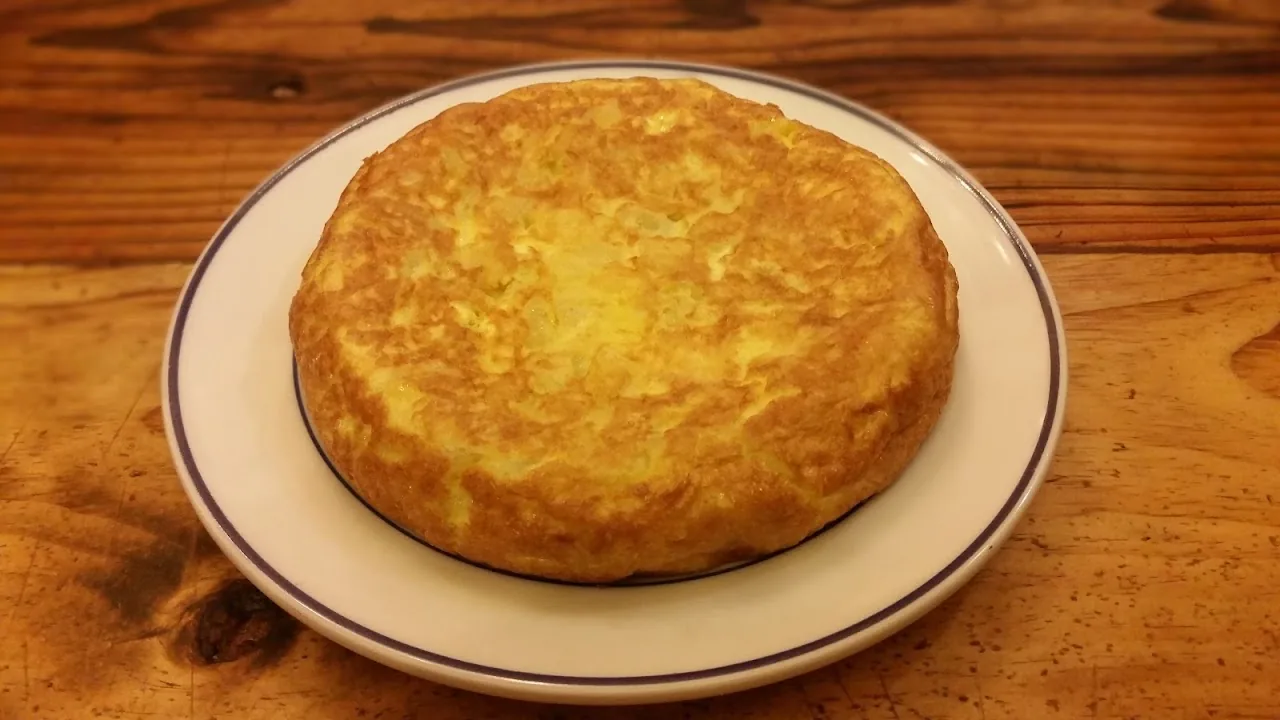 A round Spanish tortilla española on a plate