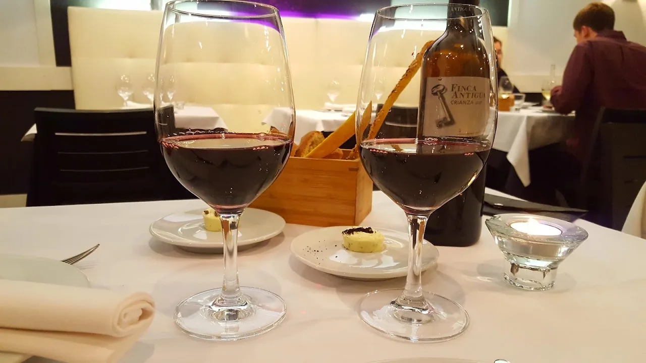 Two glasses of red wine on a restaurant table