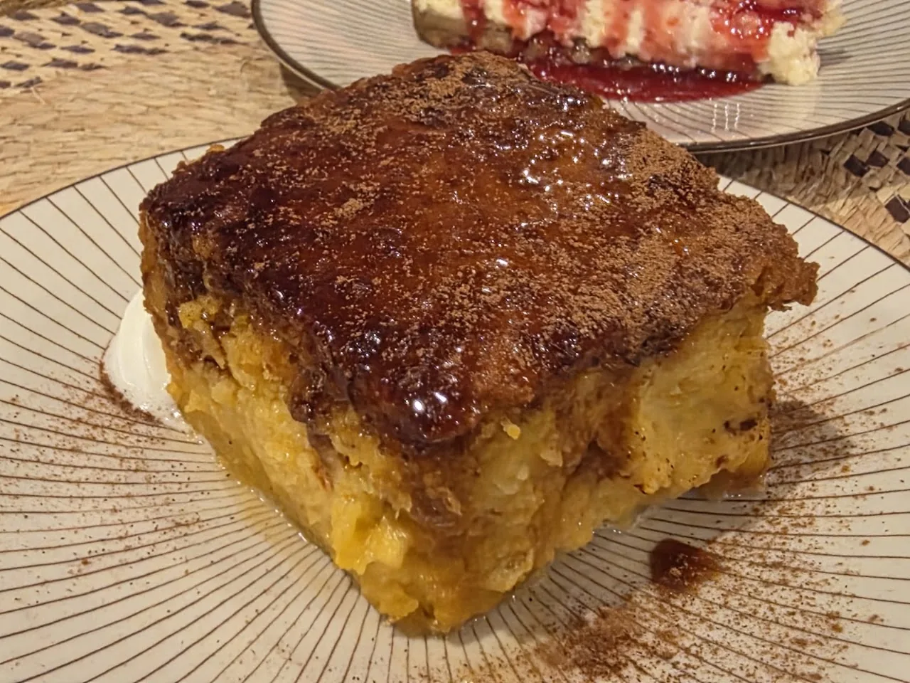 A square slice of bread pudding dessert with caramel glaze