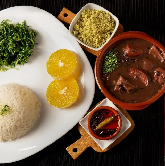 Feijoada plate with black bean and sausage stew, white rice, sautéed collard greens, orange slices, farofa, and pickled peppers, Mi Casa Bar y Restaurante