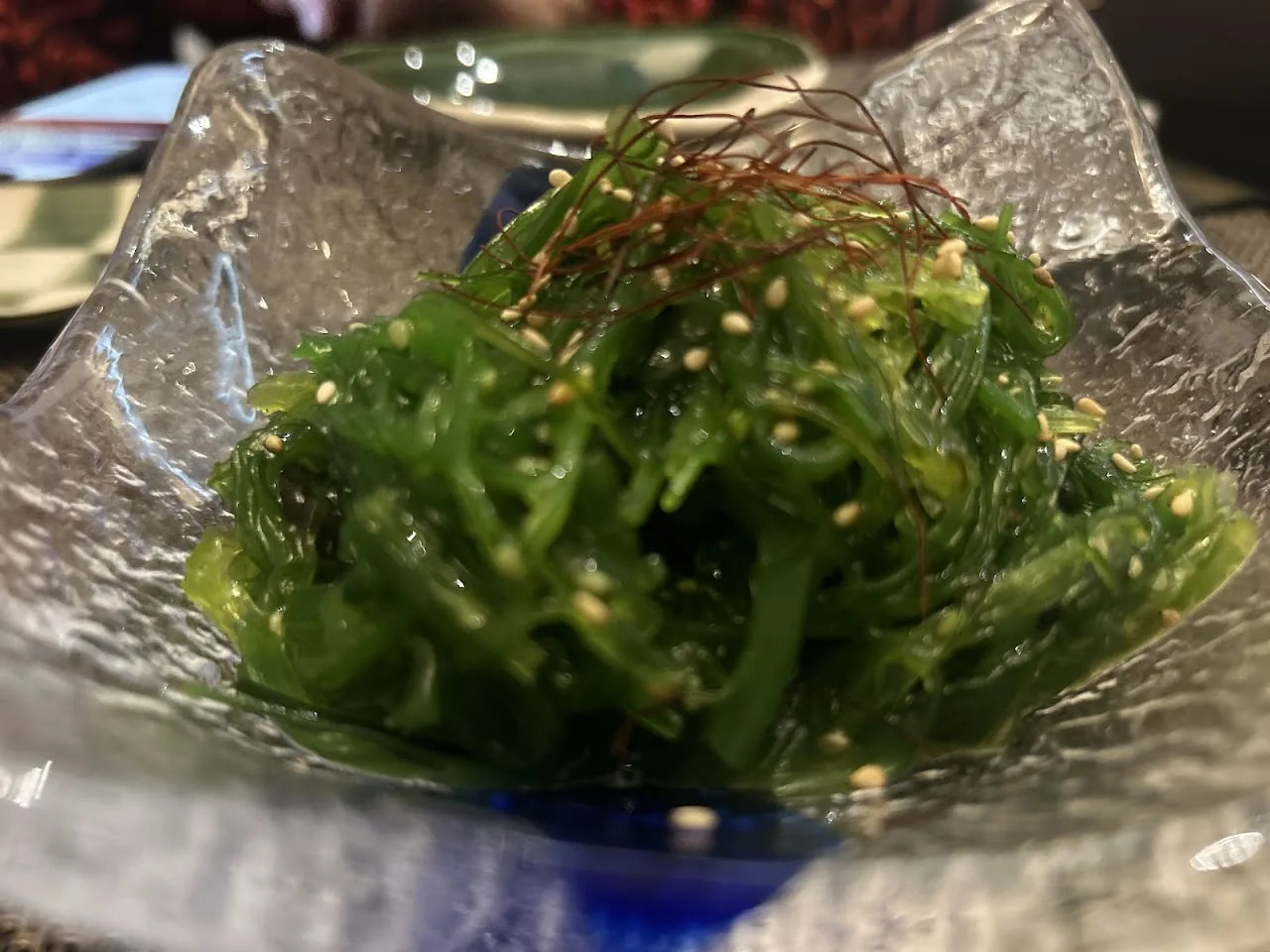 A bowl of seasoned seaweed salad with sesame seeds