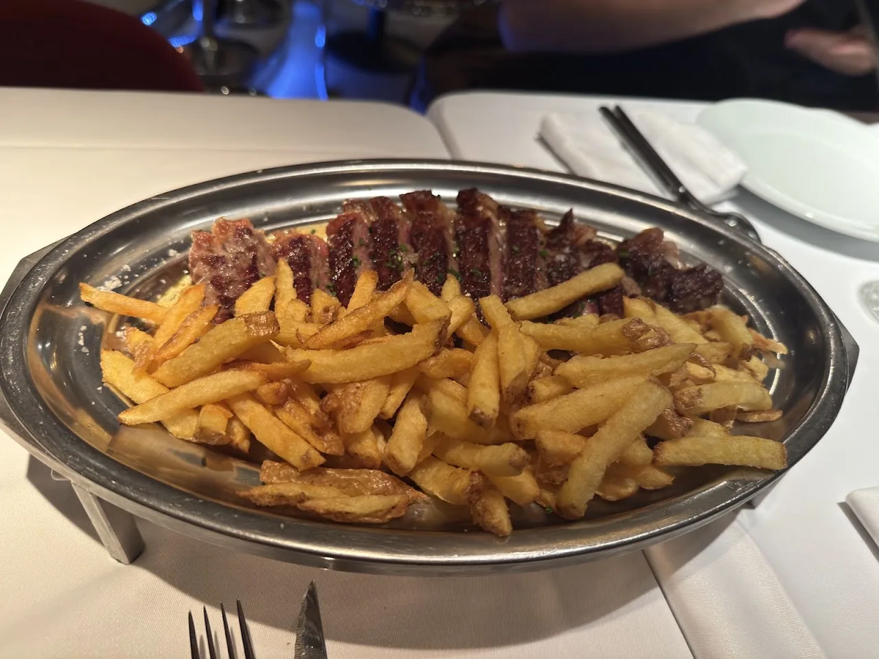 A metal plate piled with french fries