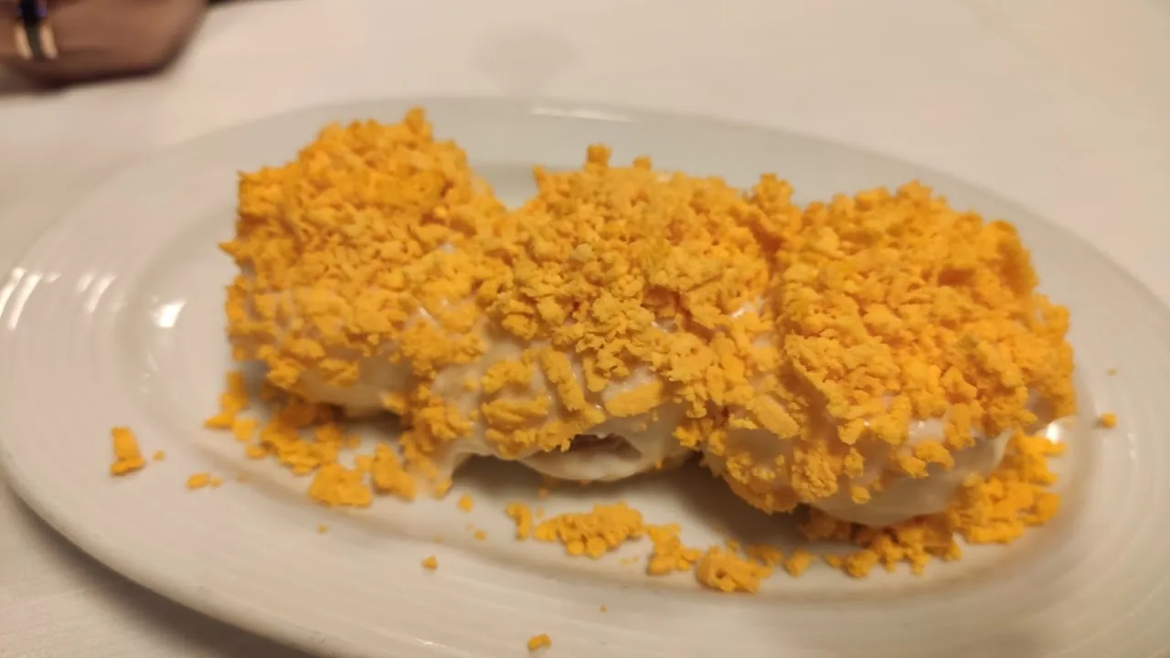 A fish fillet topped with golden breadcrumbs