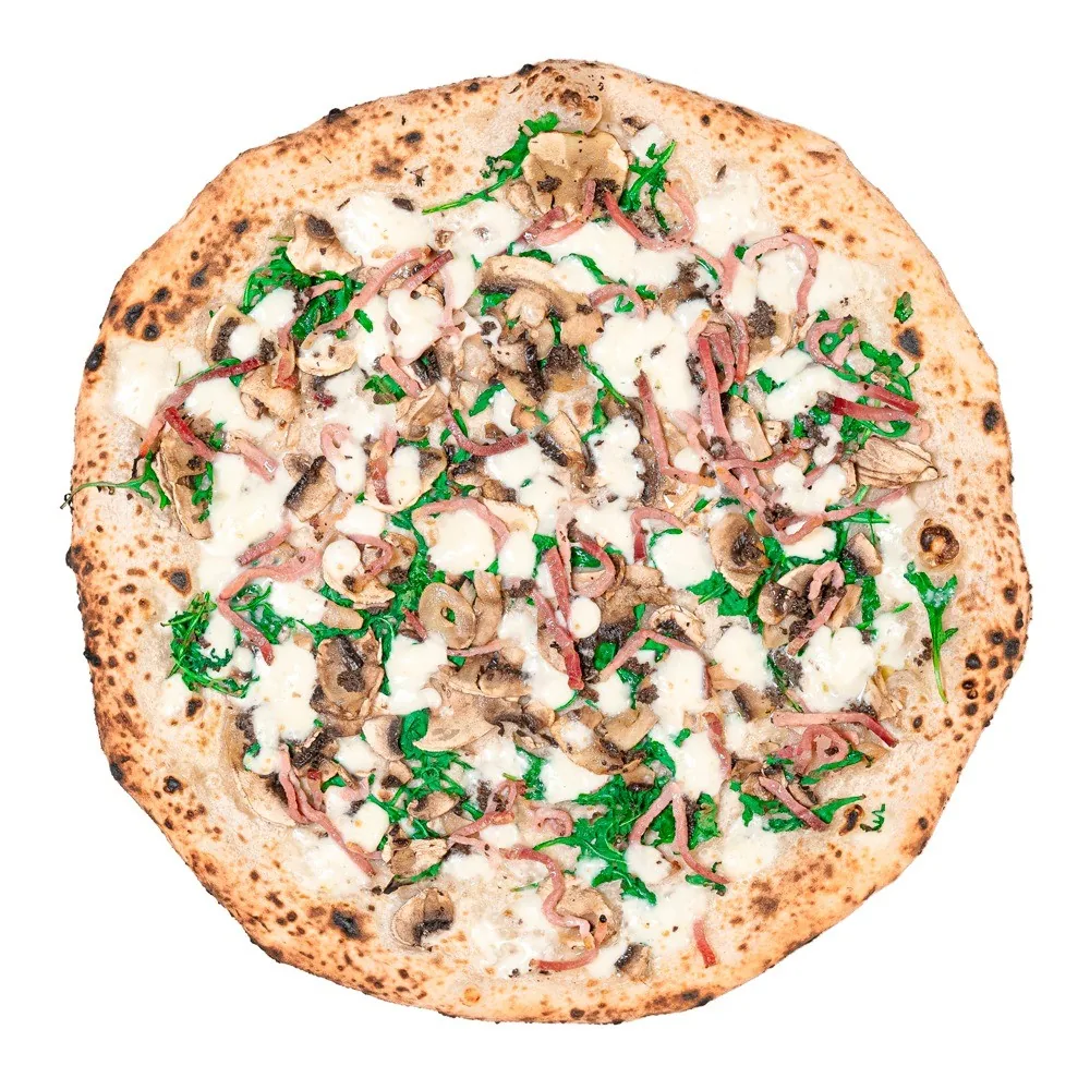 A pizza with green leaves and slices of meat, seen from above