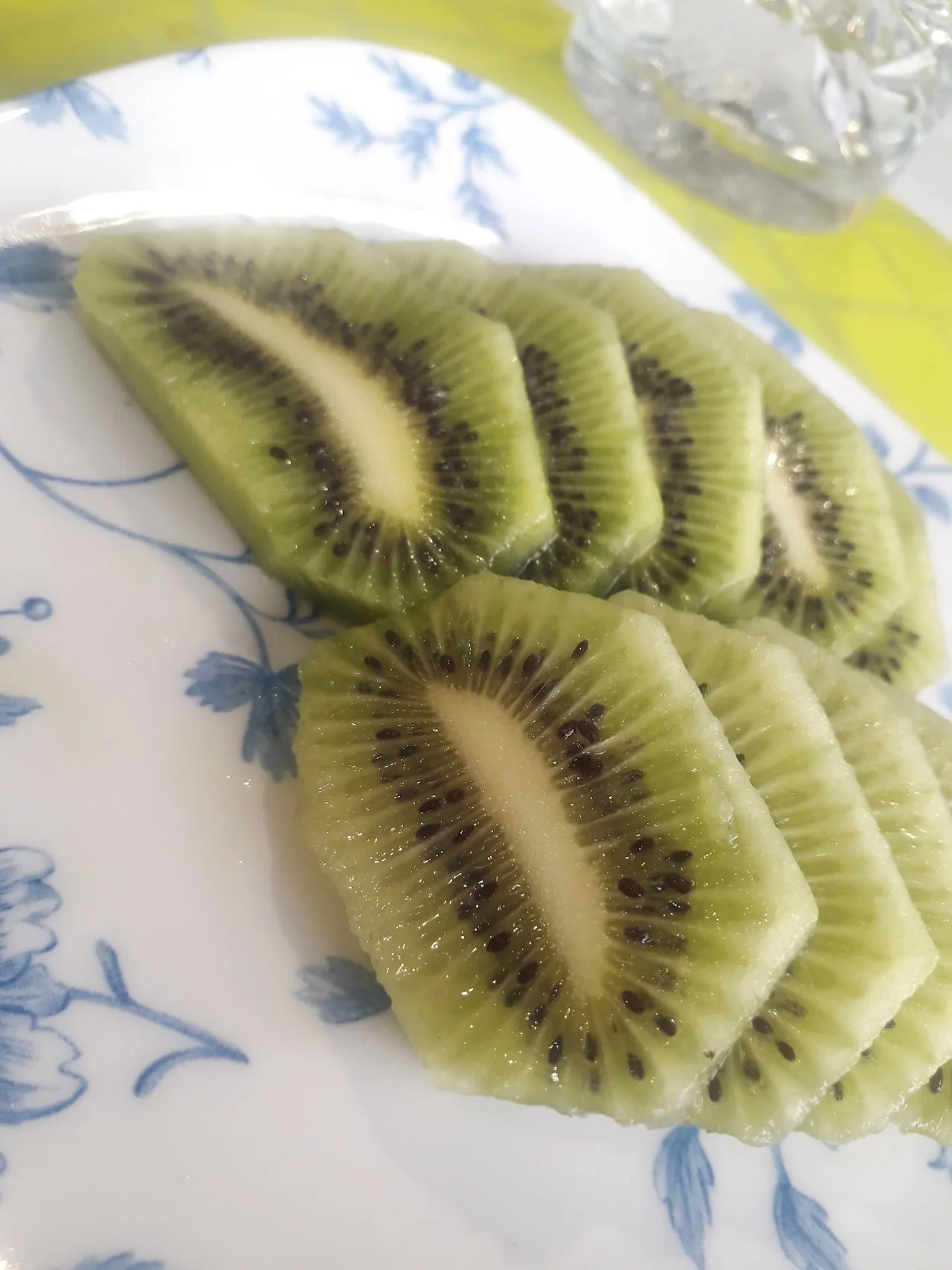 Sliced kiwi fruit arranged on a floral plate
