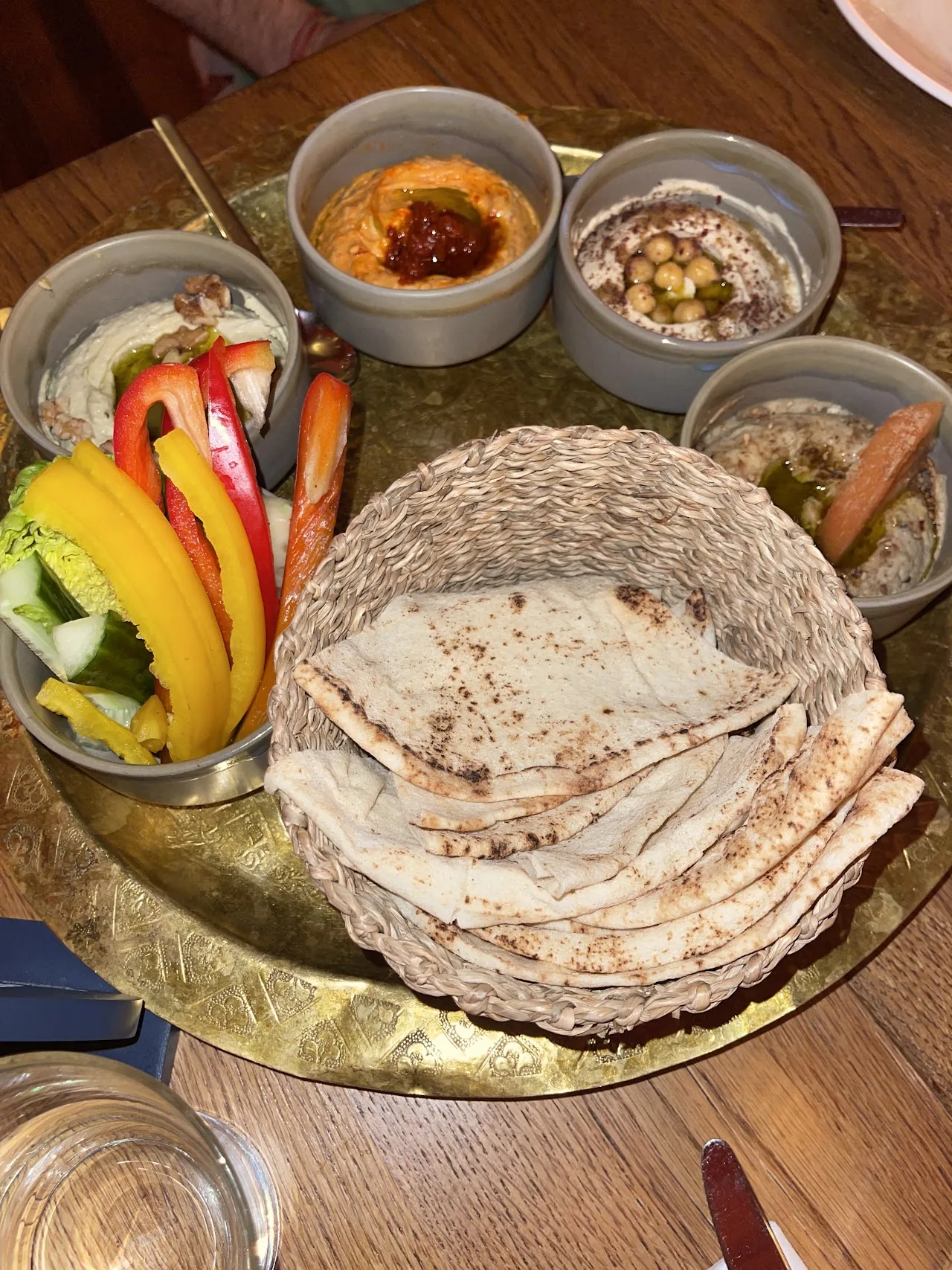 A mezze platter with hummus, dips, pickled vegetables and flatbread