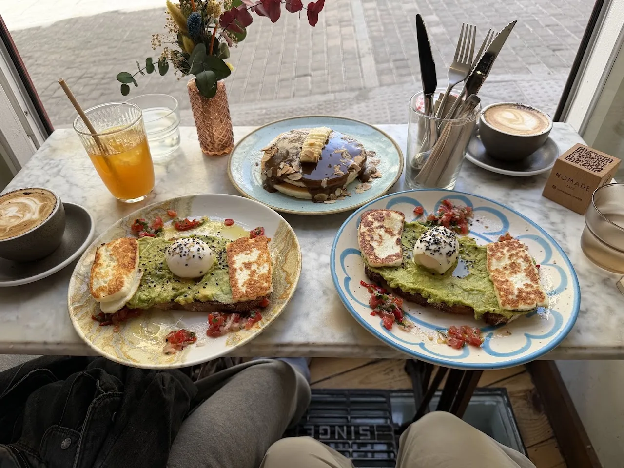 Overhead view of avocado toast, juice and a coffee on a table