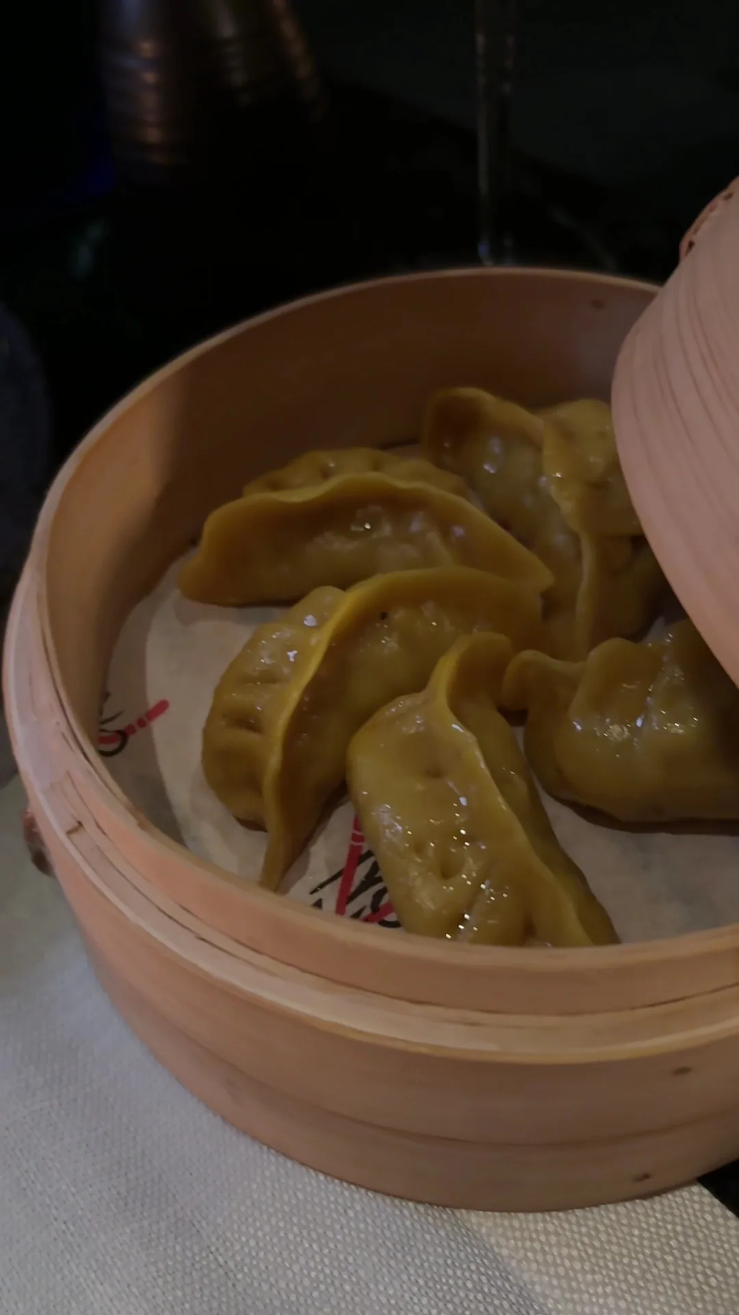 Steamed dumplings in a bamboo steamer basket
