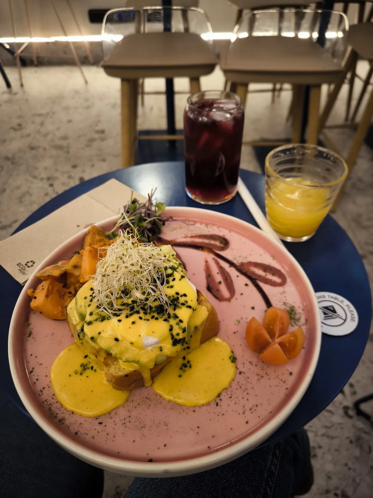 A plated brunch dish with poached egg, sweet potato and pink sauce
