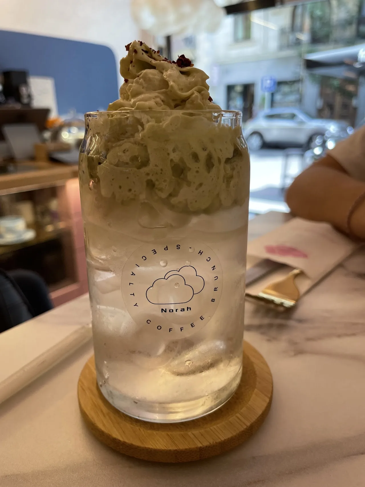 A tall iced coffee drink topped with soft-serve foam