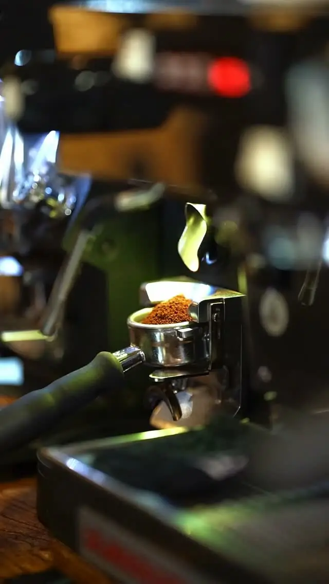 A portafilter of ground coffee at the espresso machine at Noti