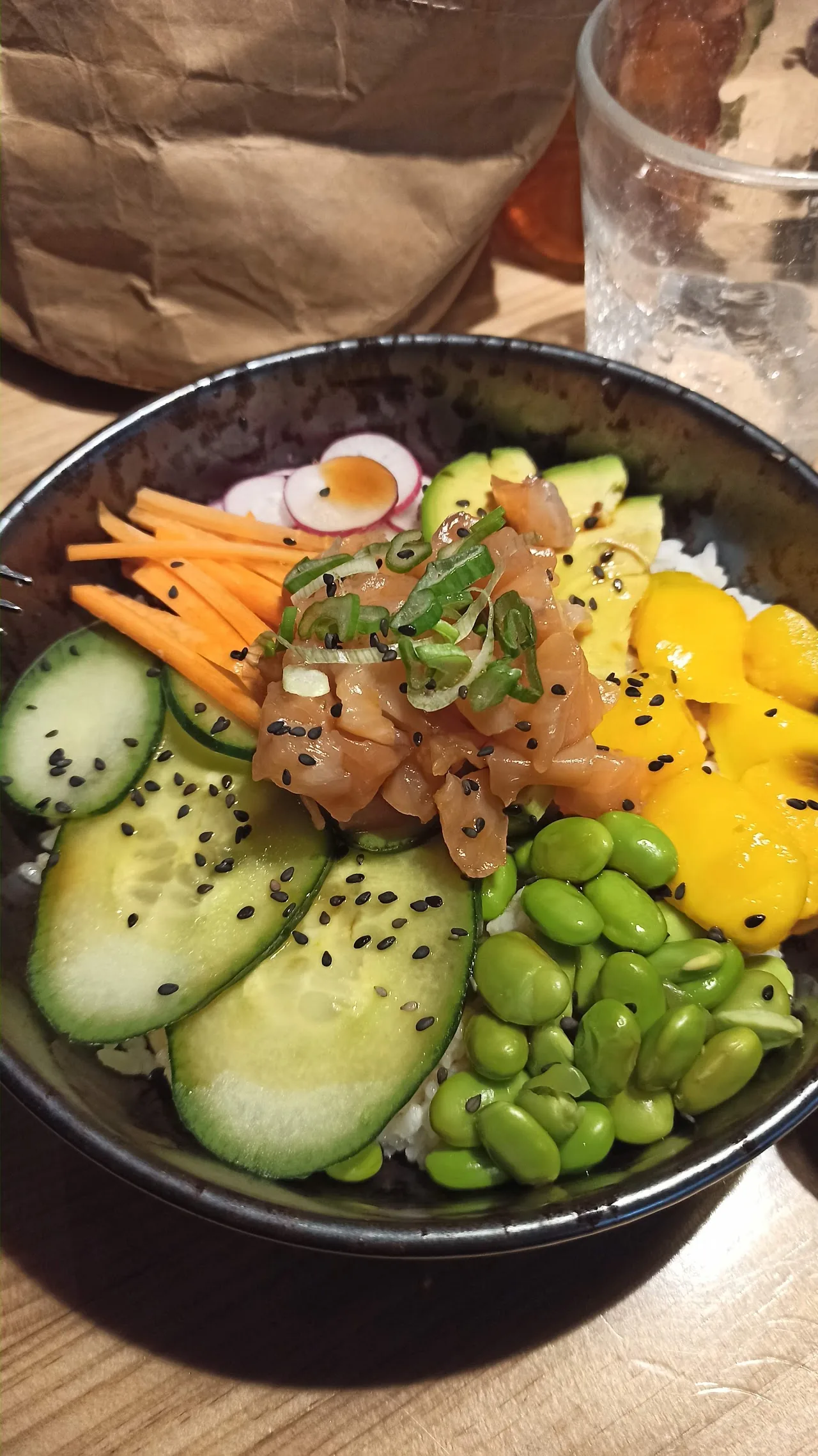 A poke bowl with edamame, cucumber, carrots and pickled vegetables