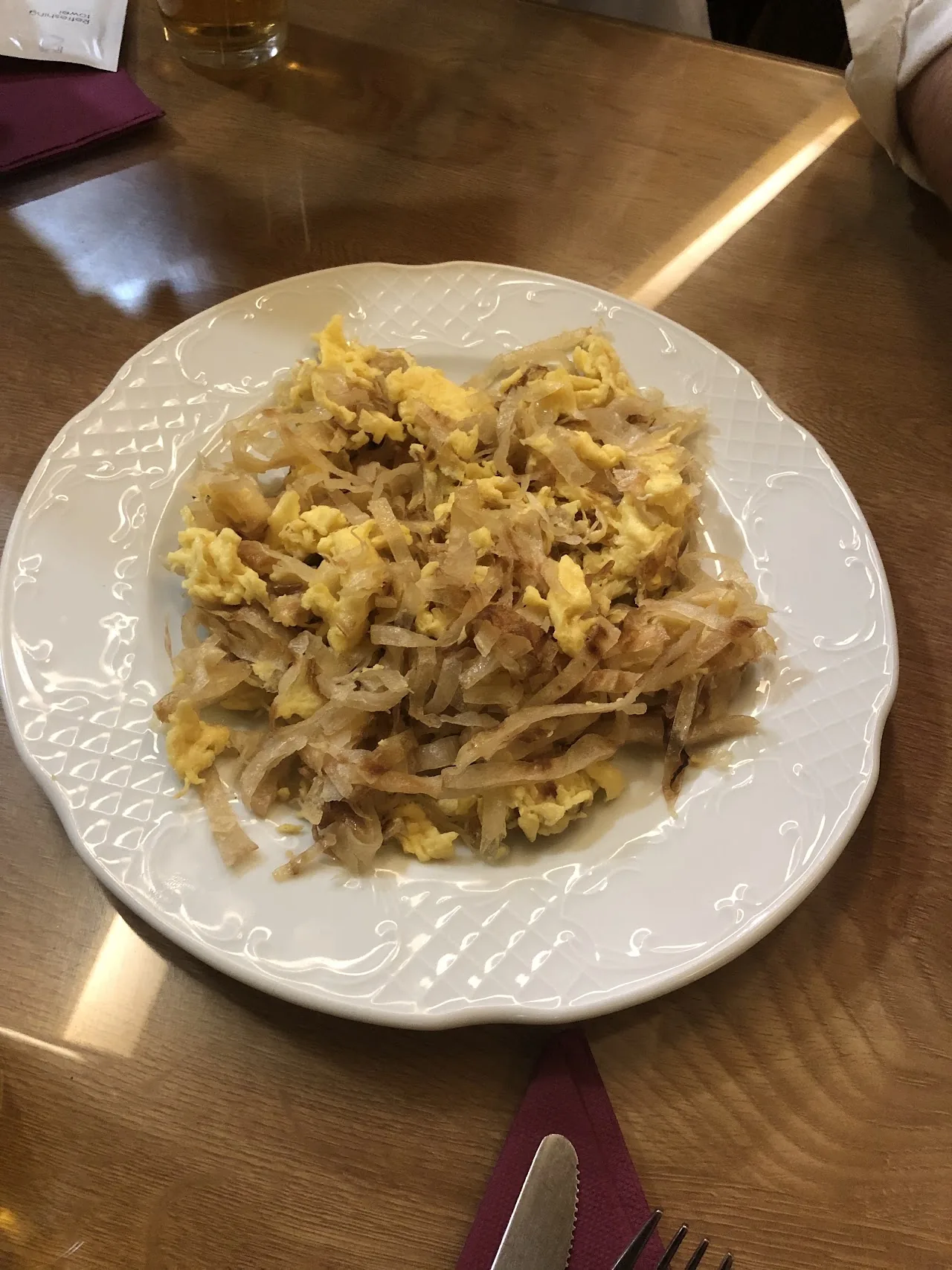 A plate of scrambled eggs with sautéed onions